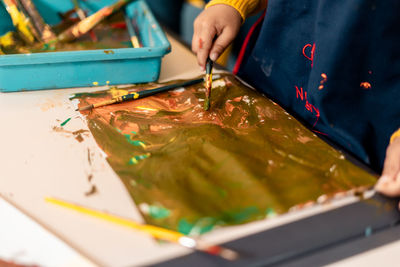 Midsection of man working on table