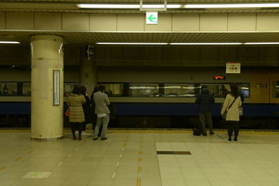Rear view of people at subway station
