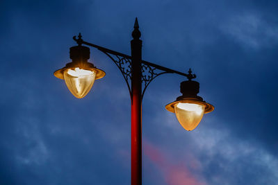 Low angle view of lamp post against sky