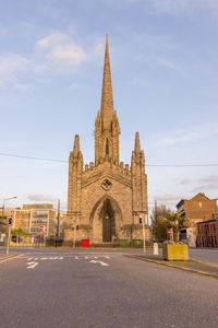 Cathedral by road against sky in city