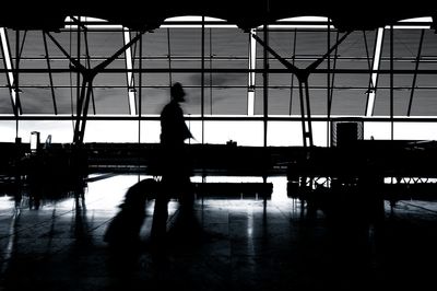 Silhouette people walking at airport