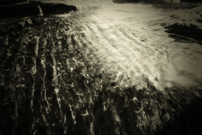 Full frame shot of water flowing in sea at night