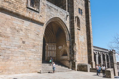 People walking in front of historical building