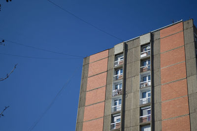 Low angle view of buildings against blue sky