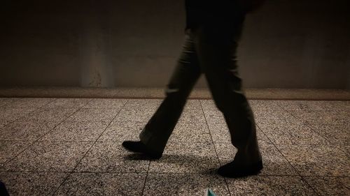 Low section of man standing on floor