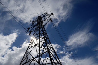 Low angle view of electricity pylon against sky