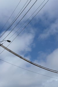 Low angle view of cables against sky