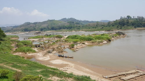 High angle view of river by landscape against sky