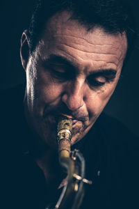 Mature man playing saxophone