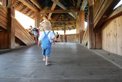 Rear view of women walking in corridor of building