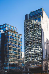 Low angle view of modern buildings against clear sky