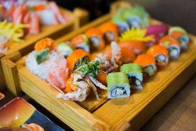 Close-up of sushi on table by philly roll and california maki