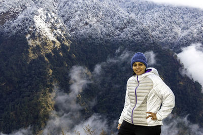 Female hiker in white jacket enjoying morning weather at ransi, uttarakhand