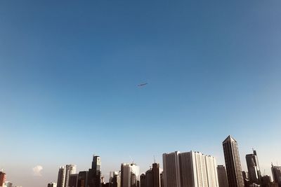 Low angle view of buildings against clear blue sky