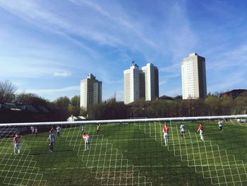 People in park by city against sky