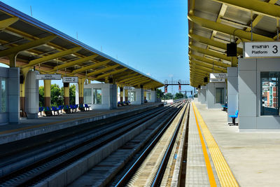 Railroad station platform against clear sky