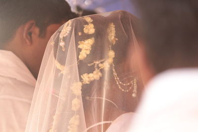 Rear view of couple holding hands