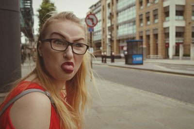 Portrait of young woman in city street