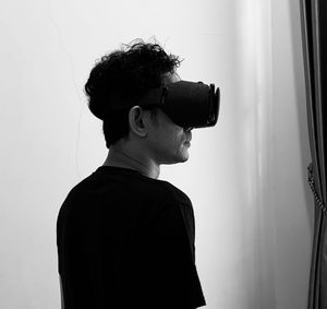 One men use vr cardboard with black and white color