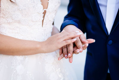 Midsection of couple holding hands