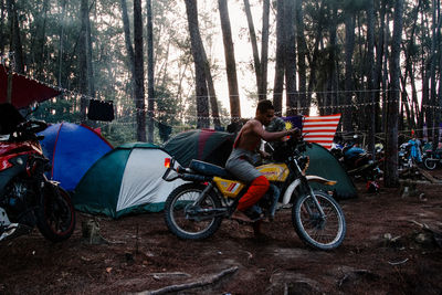 People riding bicycle on road in forest