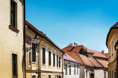 Low angle view of buildings against blue sky