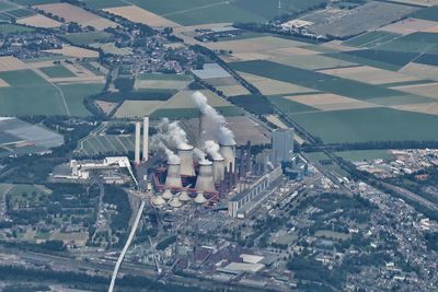 High angle view of a huge power plant producing lots of smoke