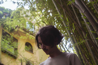 Low angle view of woman against trees