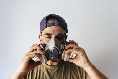 Portrait of airbrush painter putting on his protective mask.