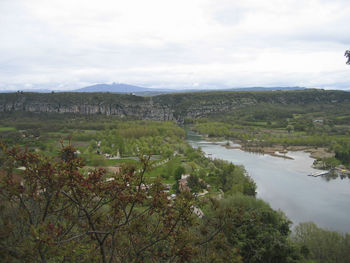 Scenic view of river and landscape against sky