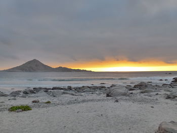 Scenic view of beach against sky during sunset