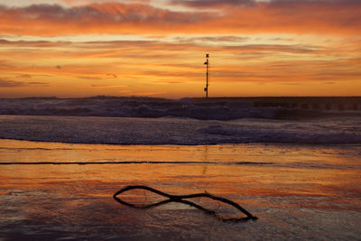 Scenic view of sea against orange sky