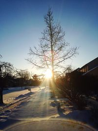 Snow covered landscape at sunset