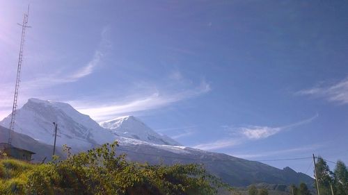 Snow covered mountains against blue sky