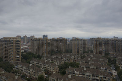 High angle view of buildings in city against sky