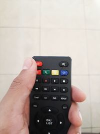 Portrait of someone holding the remote control