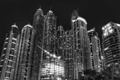 Low angle view of modern skyscraper at night