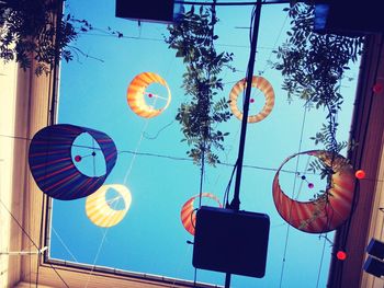 Low angle view of balloons against blue sky