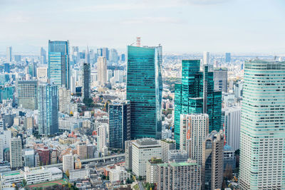 High angle view of buildings in city against sky