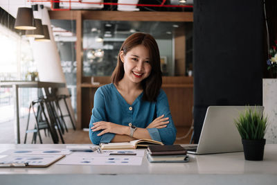 Young woman using laptop at table
