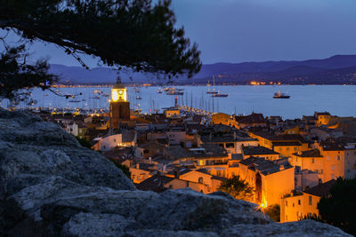 High angle view of buildings by sea against sky