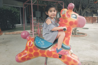 Portrait of boy playing with toy in playground