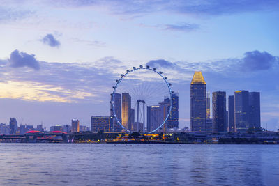 Singapore ferris wheel and business district and city, marina bay. 