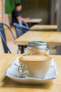 Close-up of tea and coffee cups and cake on table