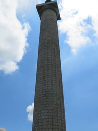 Low angle view of tower against cloudy sky