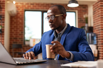 Young man using laptop at office