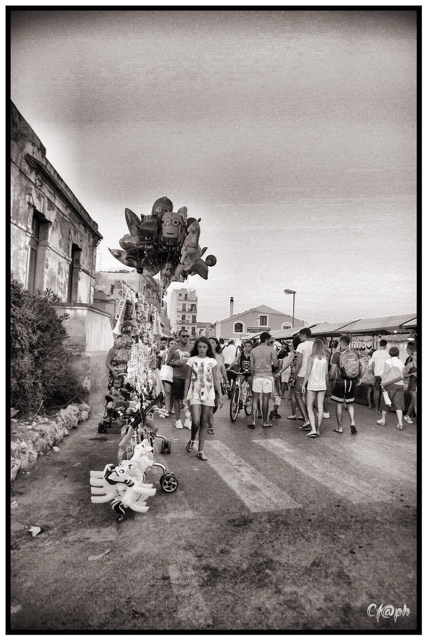 GROUP OF PEOPLE WALKING ON STREET