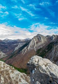 Scenic view of mountains against cloudy sky