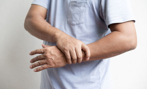 Midsection of man holding hands