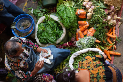 High angle view of man with vegetables at market